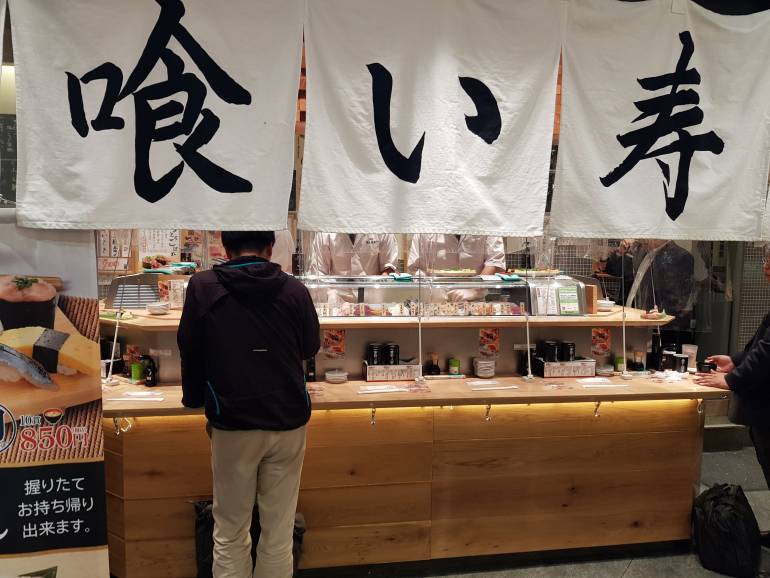 Uogashi standing sushi customer