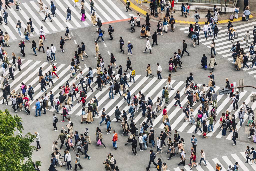 High angle view of crowds of people crossing walkway in Tokyo Japan.