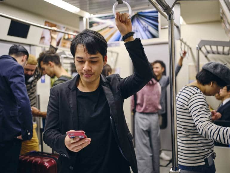 man with phone on japanese train