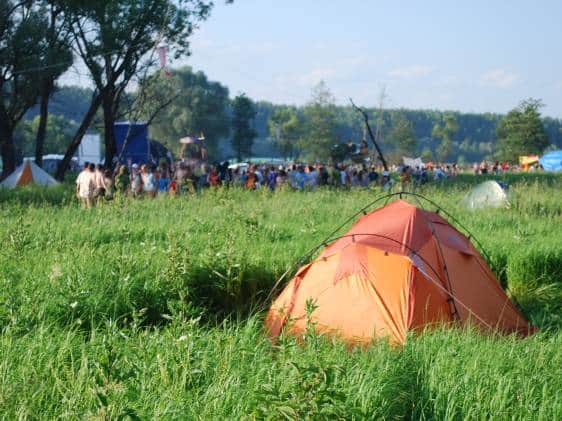 open-air tent in a field at a festival
